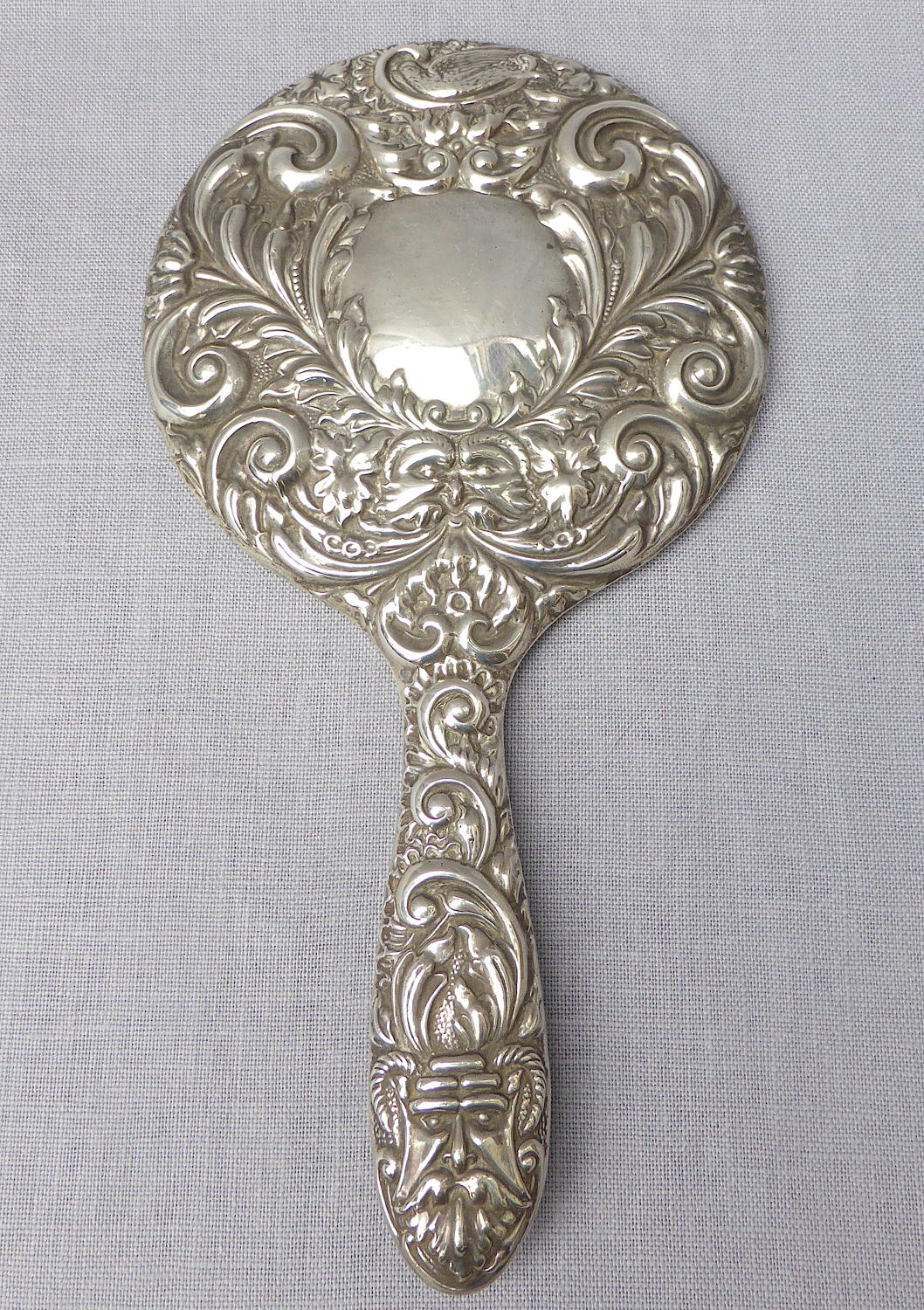 Repoussé silver hand mirror by Broadway & Co 1982
