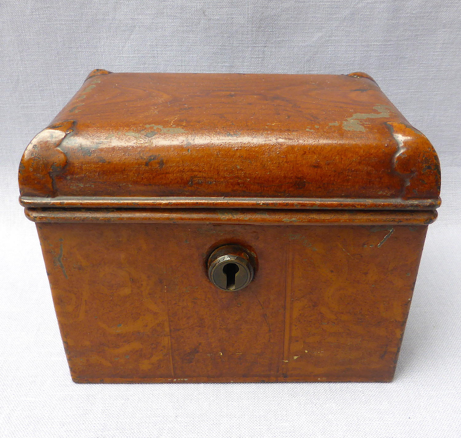 Doll's miniature tin trunk with wood grain finish