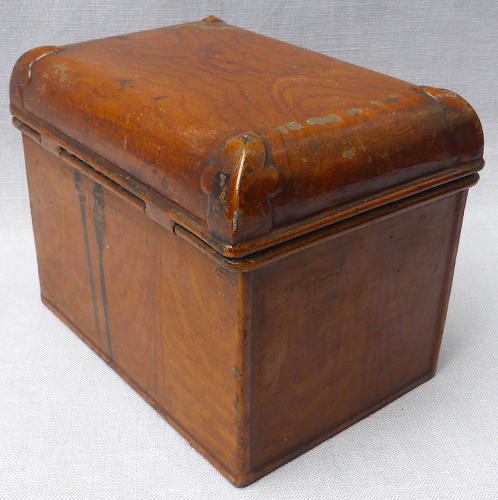 Doll's miniature tin trunk with wood grain finish