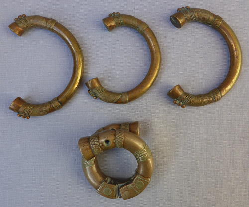 Four 19th century bronze manilla slave currency bracelets