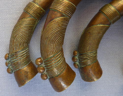 Four 19th century bronze manilla slave currency bracelets