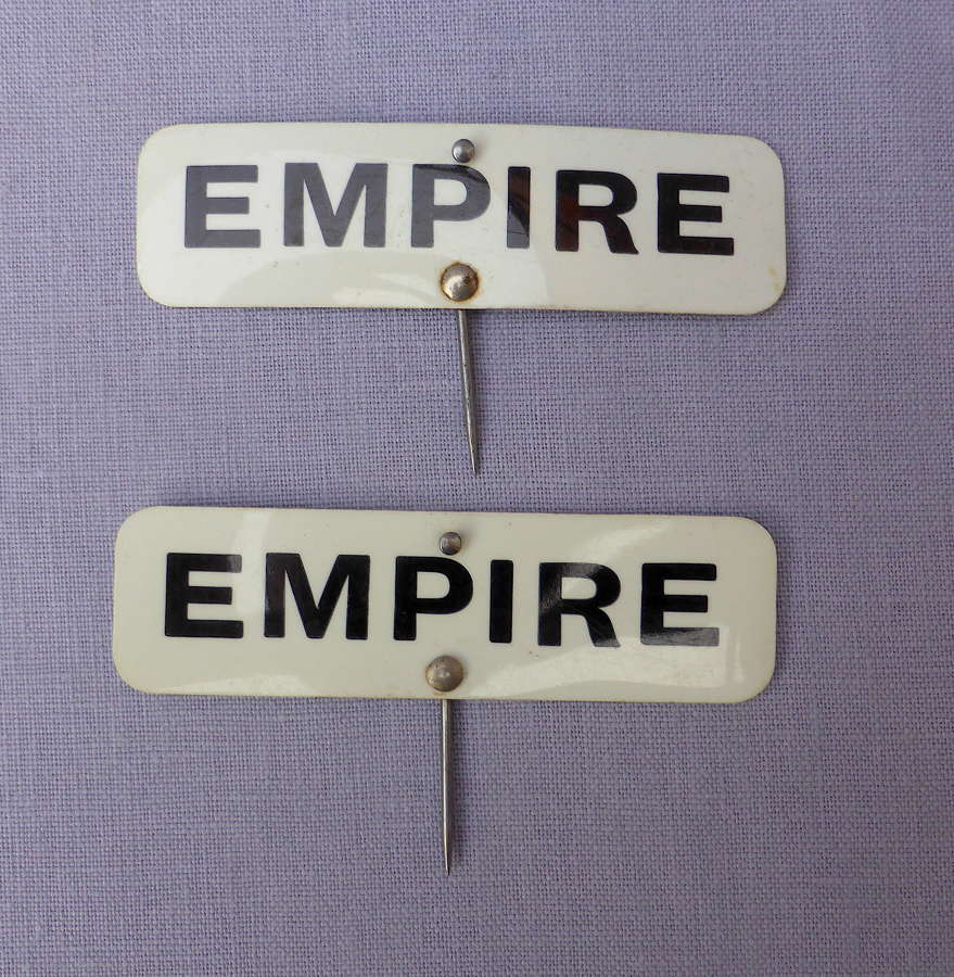 Pair of celluloid Empire grocery shop labels